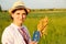 Defocus young ukrainian woman portrait. Meadow nature background. Holding ukrainian passport and bread. Smiling