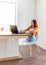 Defocus. Young woman is education online by using computer. Female freelancer browsing laptop