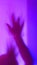 Defocused abstact silhouette of arm, hand spooky action, alien, ghost, Halloween concept, haunted and horror in multicolor