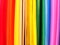 Defocused abstract background, colored stripes, vibrant rainbow colors. Materials for creativity. Colored paper.