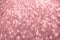 Defocused abstract pink twinkle light background. Pink gold glittery bright shimmering background