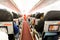 Defocused airplane cabin interior with seats and passengers