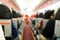 Defocused airplane cabin interior with seats and passengers