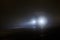 defocused alone minivan moving on empty night foggy road