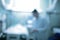 Defocused background with female doctor silhouette standing at the patient bed in the critical care unit