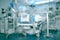 Defocused background with high-technology equipment surrounding the unconscious patient in the hospital ICU