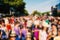 Defocused background of people partying or marching outdoors