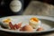 Defocused background with ready to eat eggs in vintage enamel plate. Behind blurred bacground.