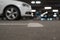 Defocused background of underground parking, low angle view. Parked cars