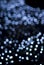 Defocused blue light dots against black background