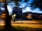 Defocused blur motion of Deliveroo biker cycling fast