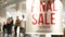 Defocused blurred background of shop window with mannequins. Final sale words on storefront. Shopping center or mall