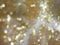 Defocused, Blurred, and Bokeh Gold Lights From A Sparkling Silky Fabric, Light Abstract for Background and Celebration Use