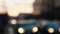 Defocused blurry car lights passing by in traffic jam, sunset on background