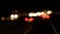 Defocused blurry street night traffic lights, view from inside the car