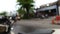Defocused bokeh blur footage of asian indonesian street at afternoon after rain with bike and car passing by