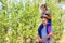 Defocused brother riding sister on back. Portrait of happy girl on man shoulders, piggyback. Girl holding cat, kitten. Family