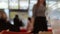 Defocused cafe scene dolly shot. Time lapse shot of crowd in mall food court view over table top with empty fast food