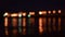 Defocused city lights reflected in water of river