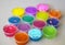 Defocused colorful slimes inside plastic boxes. Set of kids gunk toy, close up view. How to make fluffy slime at home