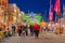 Defocused crowd of people during Christmas fair an old town street with colorful Christmas lights