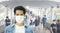 Defocused crowd wearing medical masks for virus protection and walking in walkway, blurred background, coronavirus, china covid-19