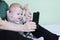 Defocused dad and little son take selfie or video call to mother or relatives in bed. Child and smartphone. Copy space -