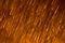 Defocused Falling orange sparks - dark orange abstract background wallpaper