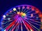 Defocused ferris wheel with colorful lights