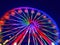 Defocused ferris wheel with colorful lights