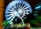 Defocused ferris wheel with colorful lights, abstract background ready for your design