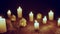 Defocused glowing candles and blinking decorative houses