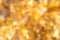 Defocused Golden Christmas Bokeh Background. Gold Holiday glowing Abstract Glitter