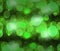 Defocused green light dots against background