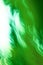 Defocused green motion blur swirling background.Colourful vortex blur green background