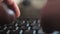 Defocused hands typing on black english keyboard