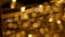 Defocused holiday lights glowing in darkness in night city streets. Abstract christmas background in bokeh. Blinking