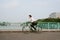 Defocused image of an active businessman riding a bicycle on the