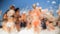 Defocused image of happy people dancing together on beach. Friends having soap foam sea beach disco party.