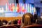 Defocused image. People in the auditorium. International conference. Flags of different countries on stage