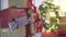 Defocused incredible view on wrapped Christmas gifts presents pile in New Year tree in decorated festive atmosphere room