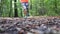 Defocused jogger running through forest in autumn