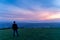 Defocused man silhouette watching how twilight begins yielding to daylight at Dublin city