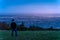 Defocused man silhouette watching how twilight begins yielding to daylight at Dublin city