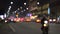 Defocused Milano traffic lights and cars at night. Blurred image of Milan