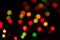 defocused multicolored new years lights on dark background