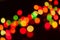 Defocused multicolored new years lights on dark blurred background