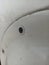 defocused object of small screw installed on white plate