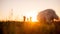 Defocused panoramic diversity family with Samoyed running at sunset with kite in sky