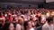 Defocused people applaud after the premiere.